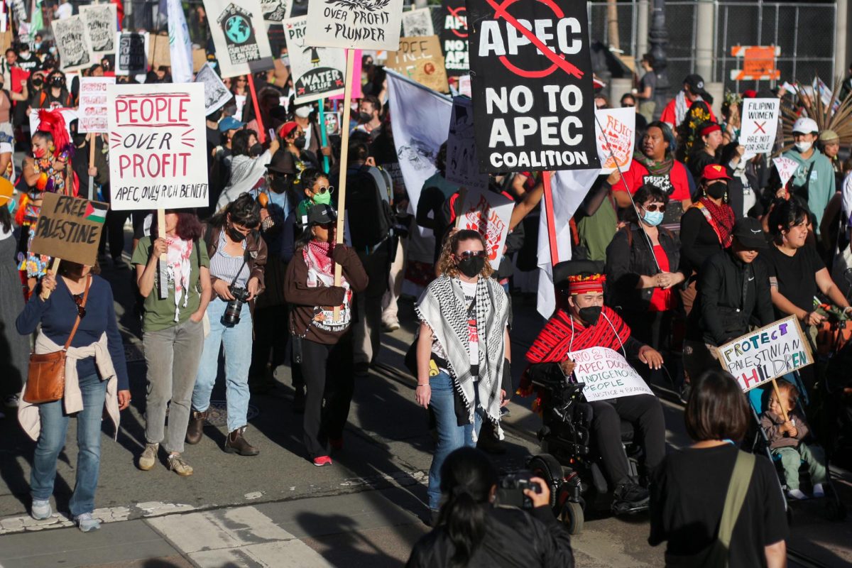 The procession moves down Market St., protesting against the APEC 2023 summit in San Francisco.