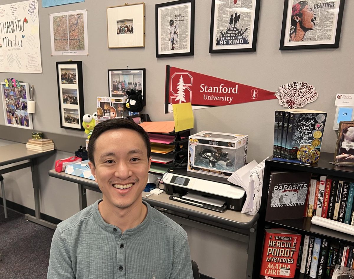 English Teacher Derek Lu in his homey classroom decorated with literature-themed art and items.