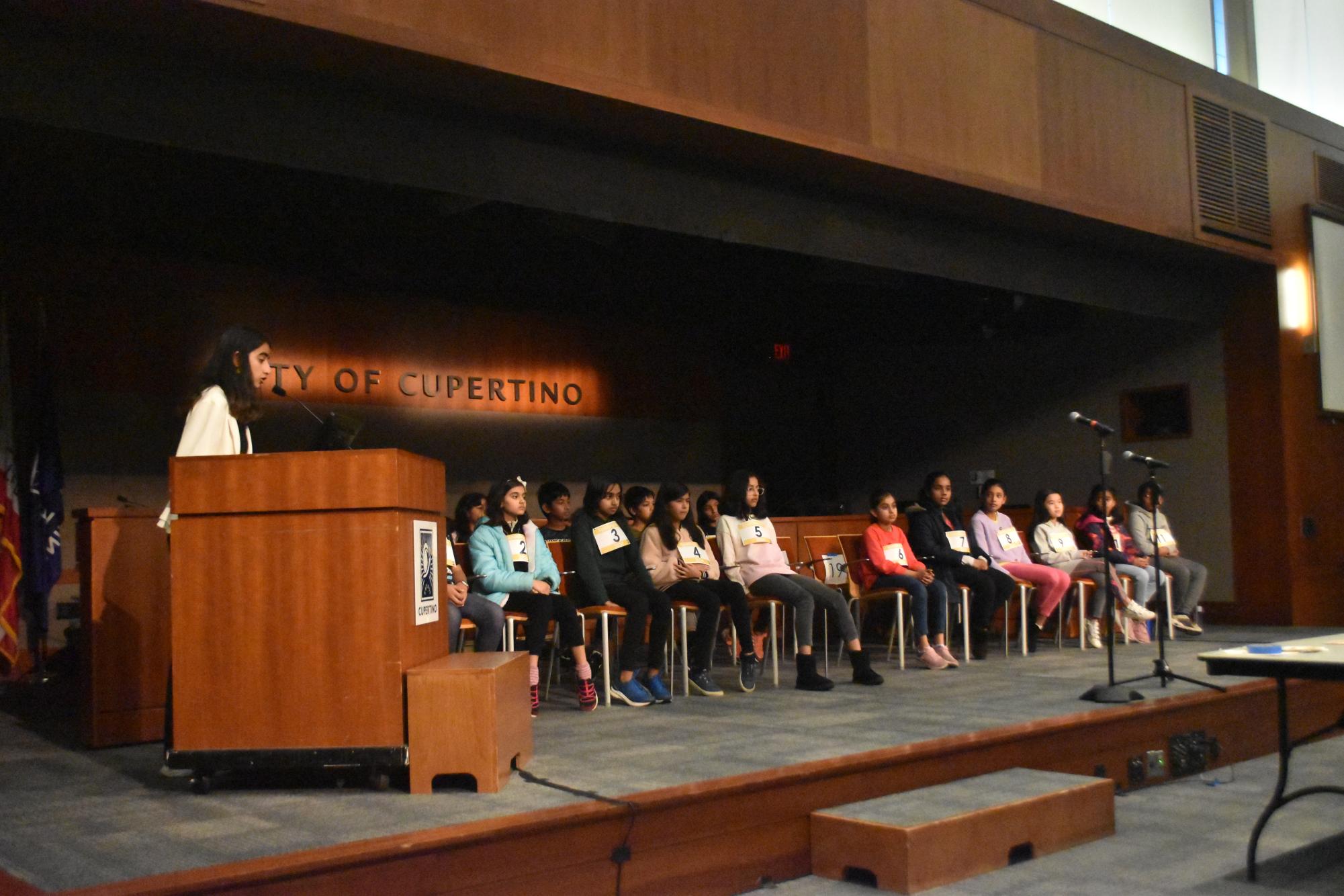 Teen Commission member Rayna Shah commences the fourth and fifth grade spelling bee by introducing the rules.
