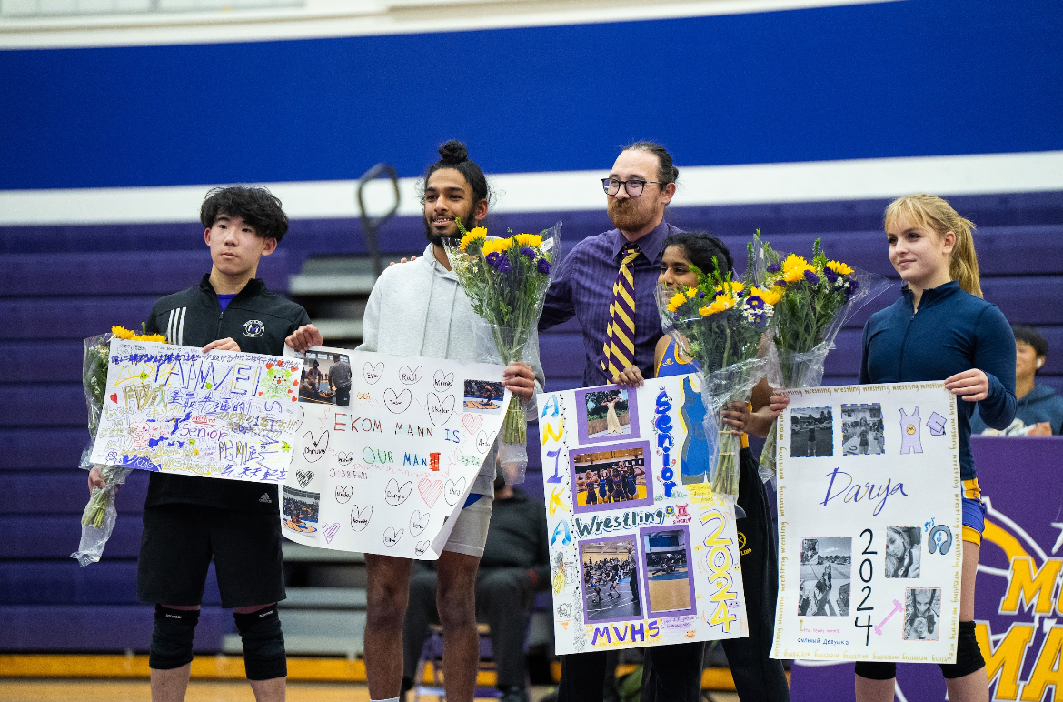 Seniors Yanwei Zhou, Ekom Mann, Anika Manjesh and Darya Pereverzeva (left to right) pose together while Coach Andrew Pappas stands proudly behind them.