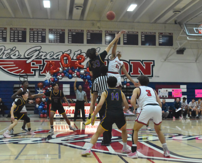 Senior Tate Jun springs into the air at the beginning of the game to fight for the jump ball.