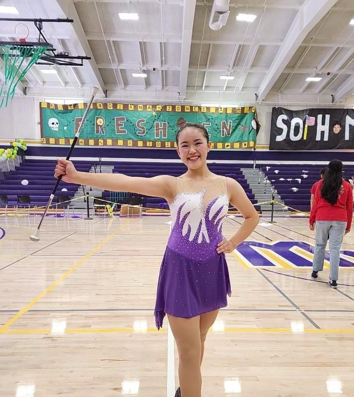 Junior Kimika Shimazaki poses with a baton after performing at the Welcome Back rally. 