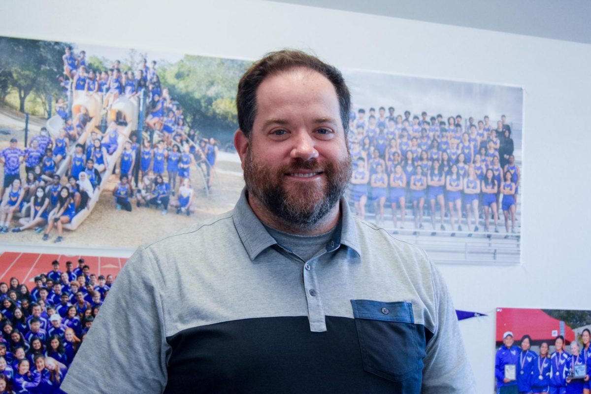 Athletic Director Nick Bonacorsi’s classroom is decorated with trophies, photos, and jerseys.