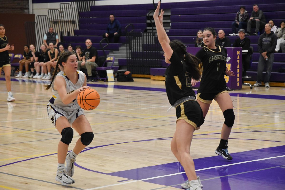 Freshman and forward Allie Rummelhoff dribbles the ball while being guarded by an opponent. 
