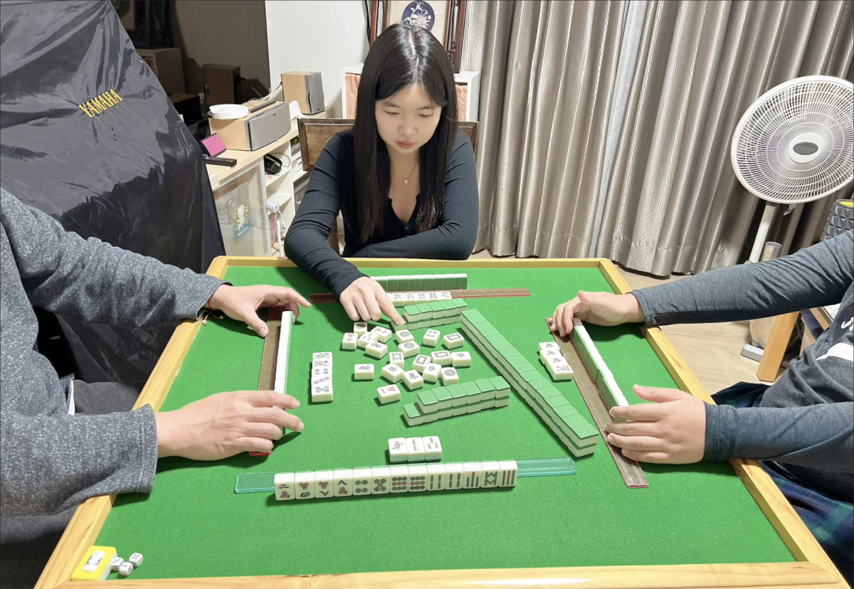Senior Catherine Chen plays mahjong with her family.