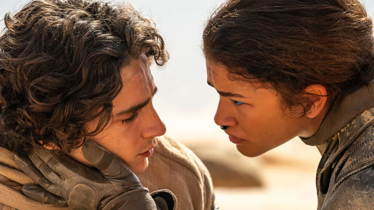 Chani, played by Zendaya, embraces Paul, played by Timothée Chalamet. Photo by Warner Bros. Pictures