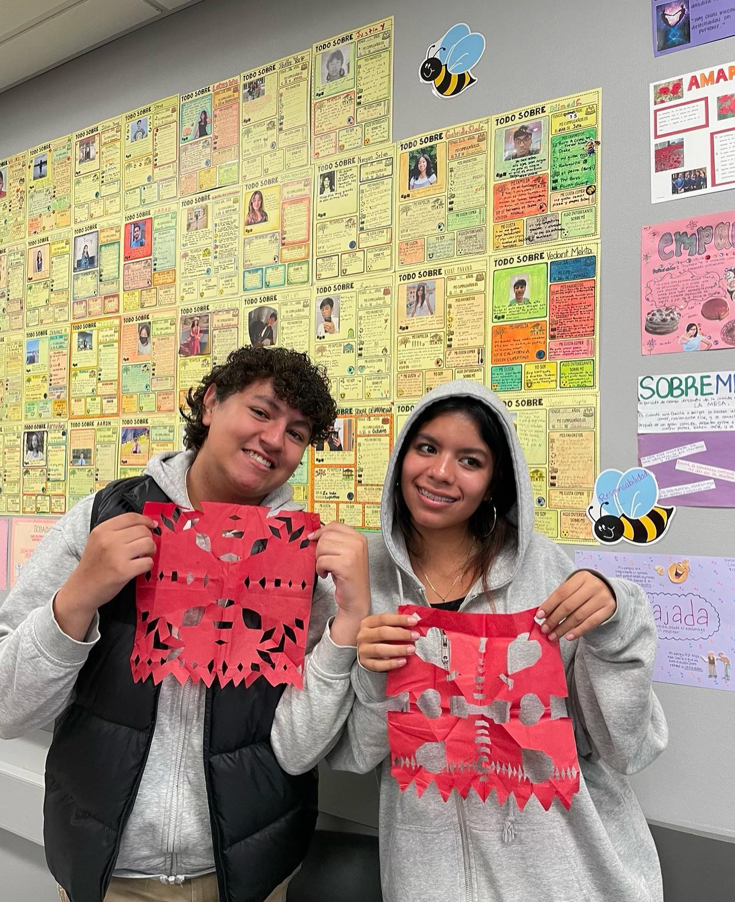 Members of Spanish Honor Society hold up papel picado they made to celebrate Día de los Muertos. Photo by Tanvi Parupalli | Used with permission