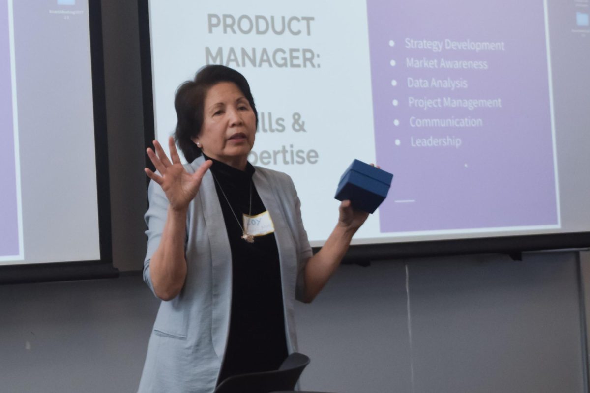 Product Manager Loy Oppus-Moe presents a box as an example product. Photo by Ethan Kellogg.