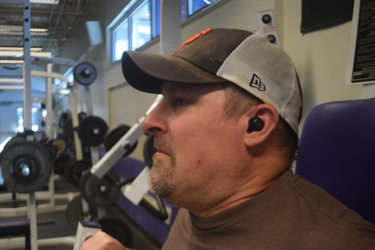 PE Teacher Jeff Thomas works out with earbuds on