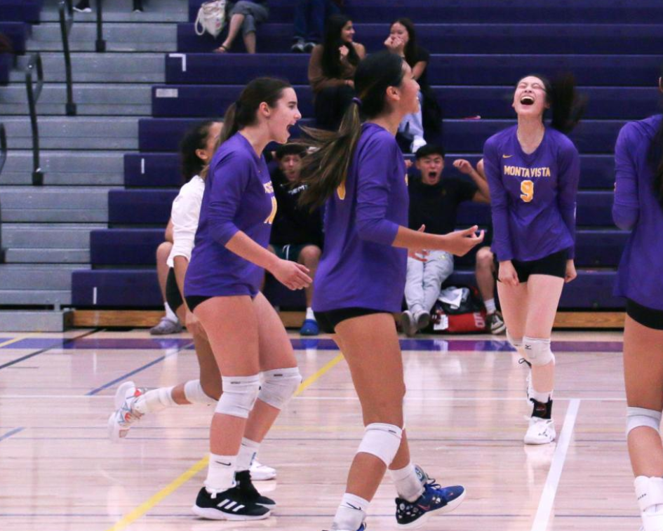 Melissa Gonchar celebrates with her team after a successful block.