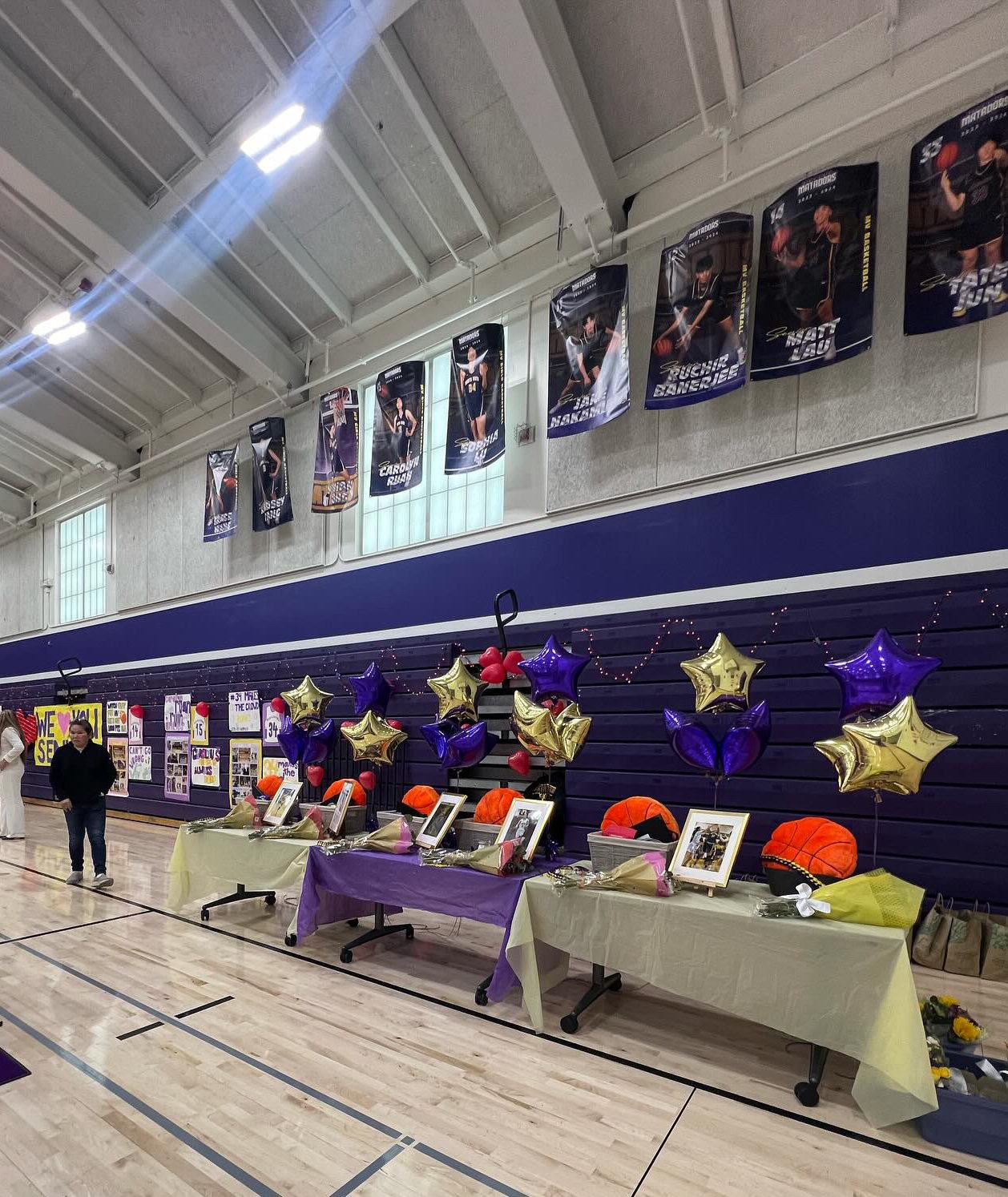 A setup of Girls Basketball senior night. Each table contains a gift basket, flowers and the homemade scrapbooks. Photo courtesy of Miya Kosakura | Used with permission