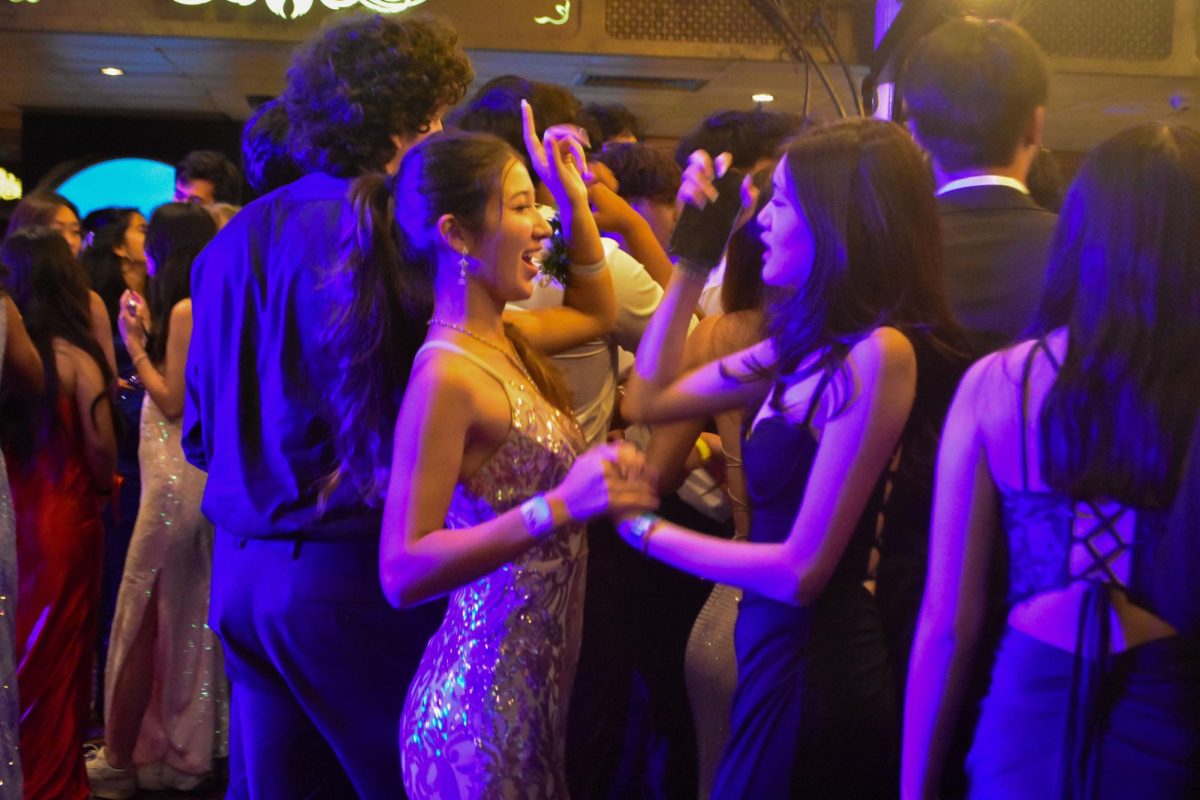 Juniors Lilia Murase and Julie Yu sing and dance along to the music.
