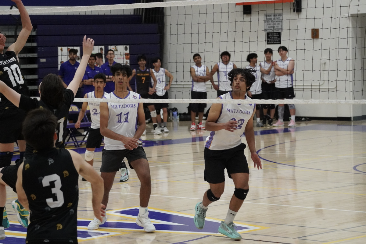Sophomore and middle blocker Pratham Kannan alongside senior and outside hitter Varchas Athreya get ready to receive the ball from Mountain View High School.