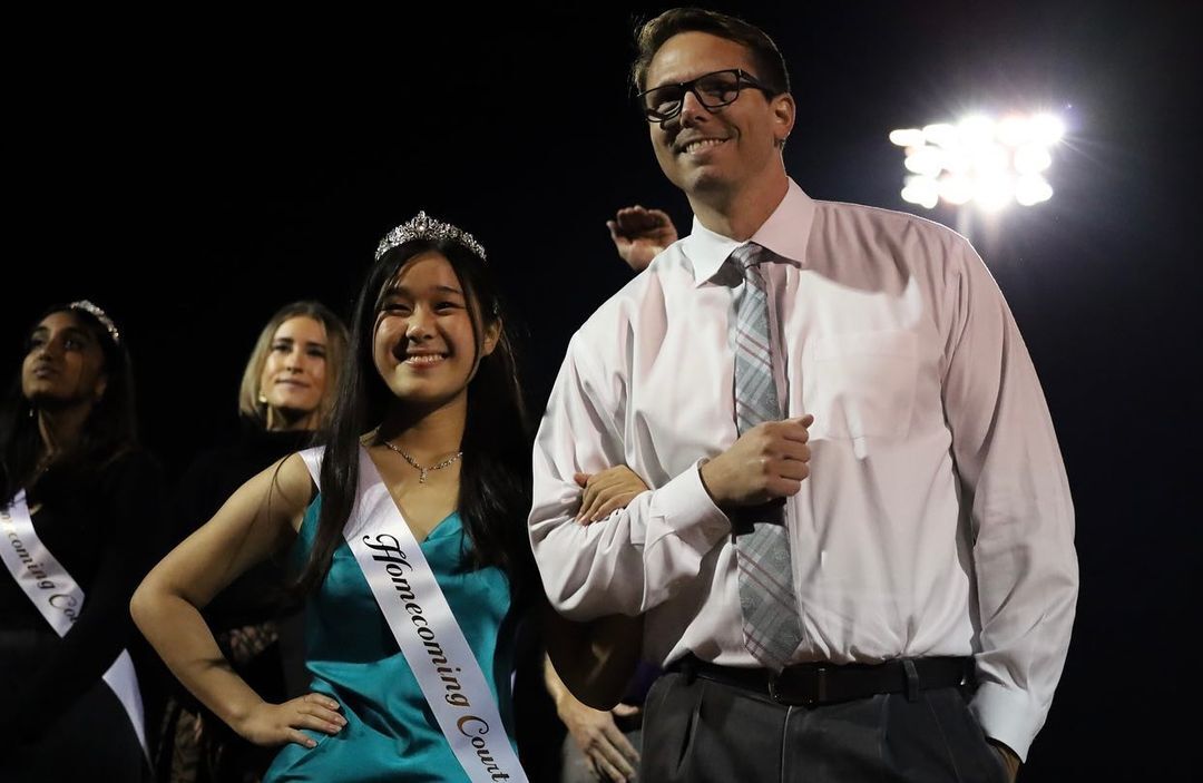 Stiver escorts then senior Kelly Tung for the 2022 Homecoming Court.