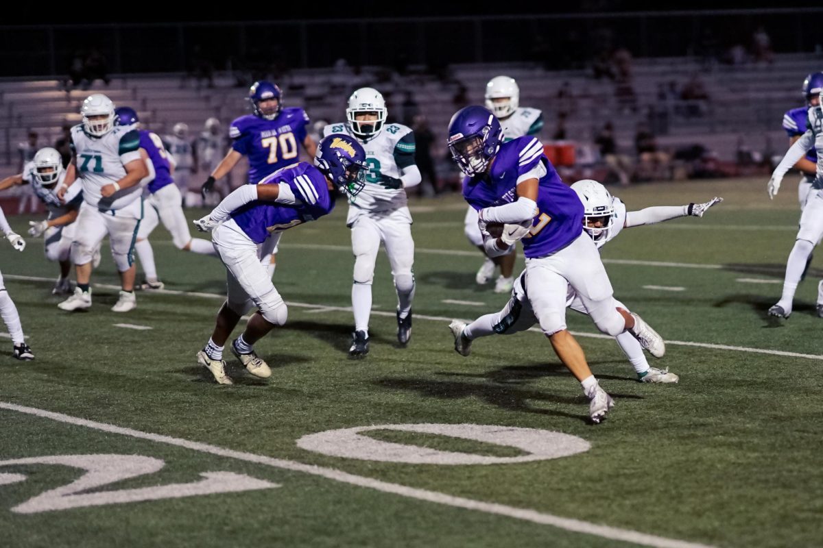 Senior and wide receiver Trevor Chan narrowly escapes being tackled while running the ball.
