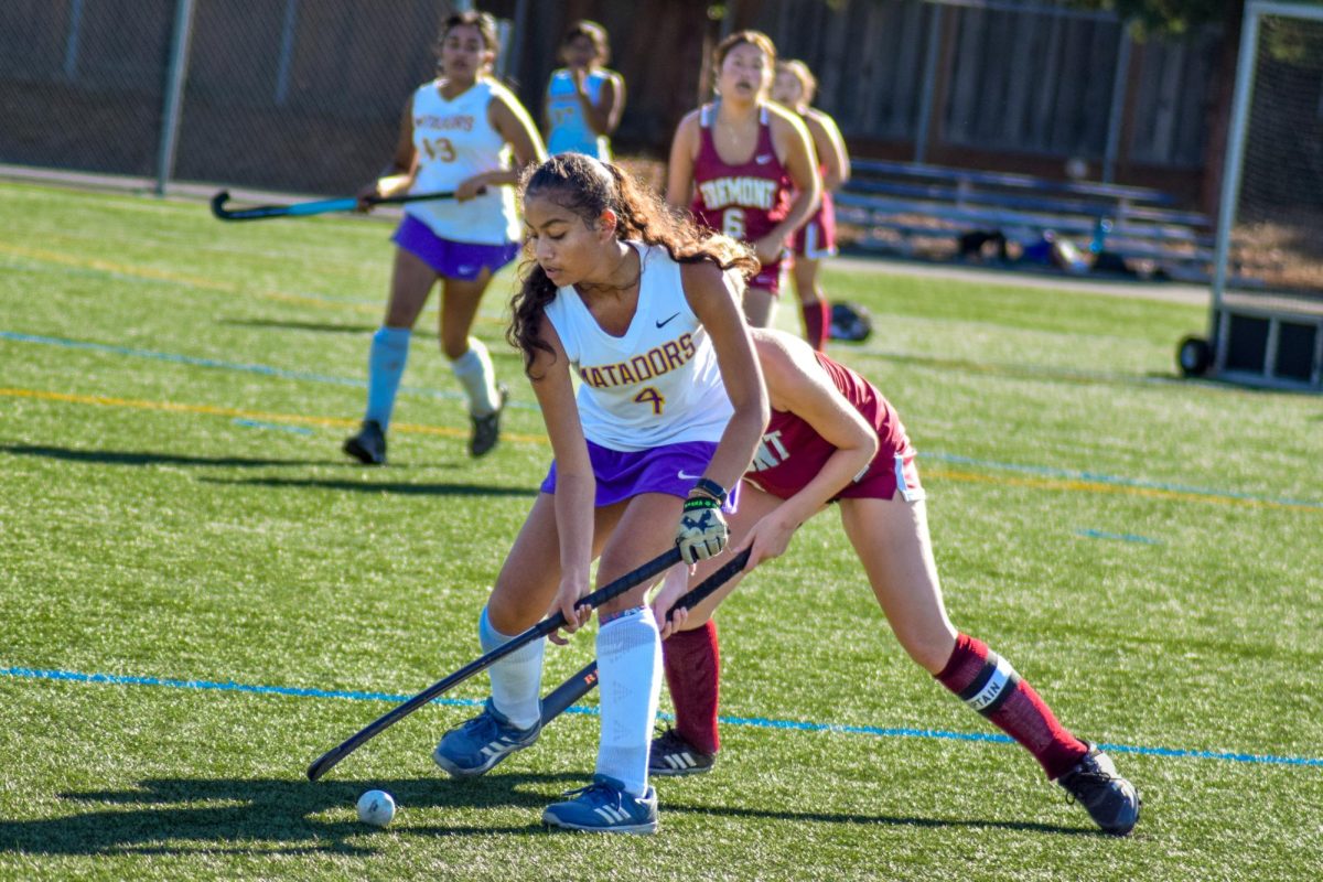 Junior Monisha Preetham defends against a player, trying to move the ball further down the field.