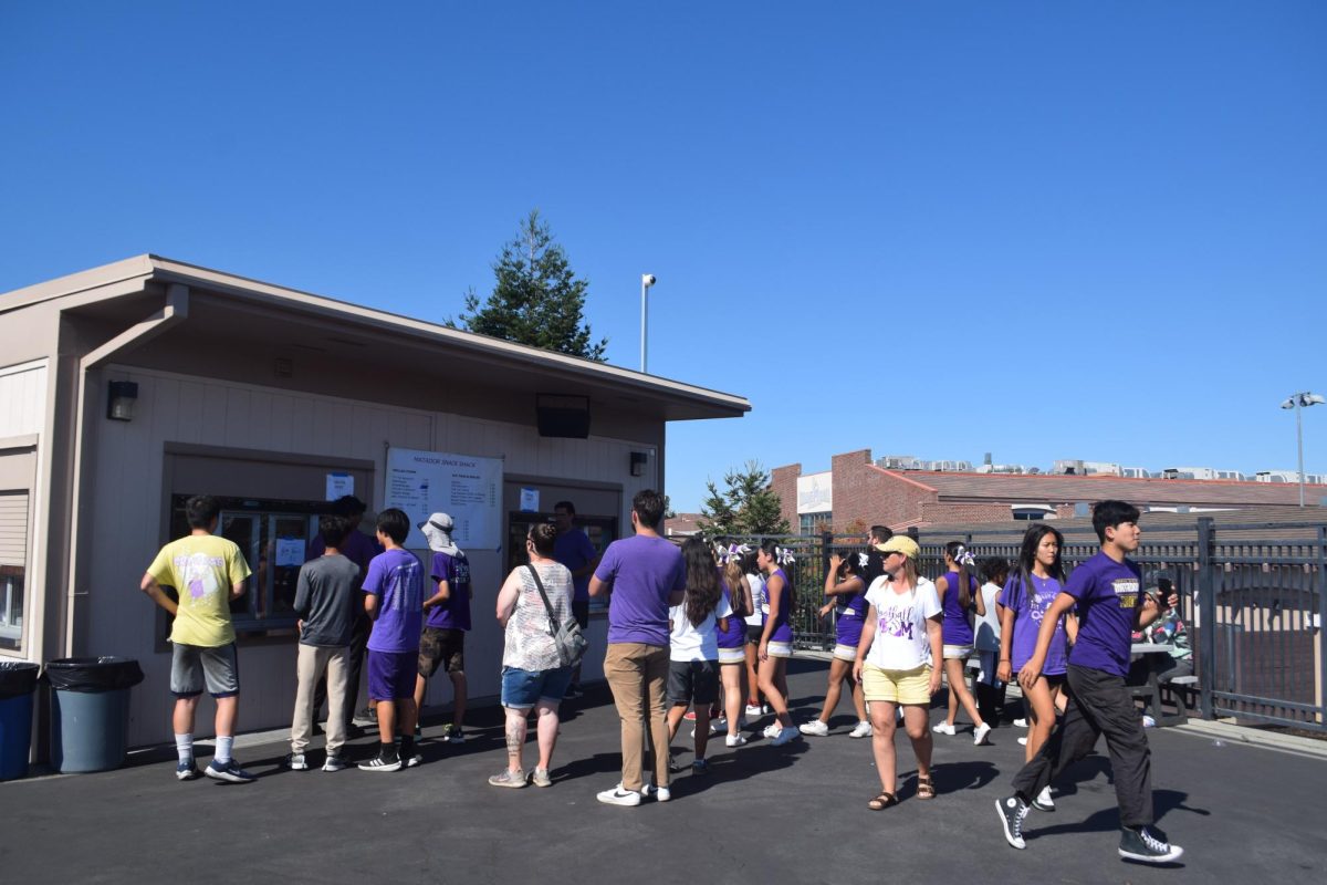 Spectators wait in line to purchase snacks and drinks at the Snack Shack during Varsity football’s game against Kathleen MacDonald High School on Sept. 14. Photo by Saailey Palekar | Used with permission