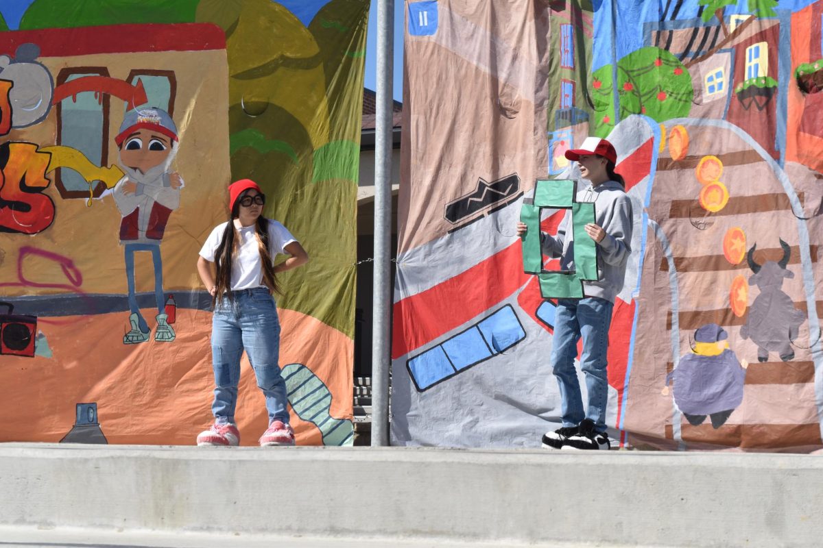 Senior Maya Pullara poses alongside senior Nathan Chiang in the Class of 2025 "Subway Surfers" themed skit.