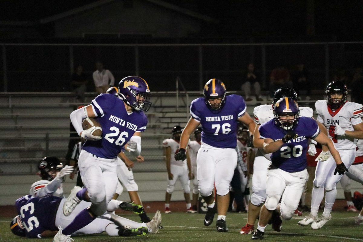 Junior and defensive free safety/wingback, and quarterback Graham Ischo secures the ball and runs past the defense after an interception from GHS.