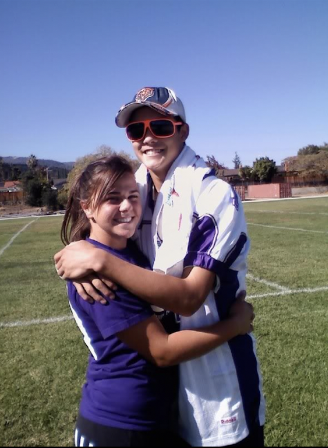 Voigt and her high school sweetheart embrace for a photo during a homecoming role-swap game where Voigt participated in football while her boyfriend cheered from the sidelines. Photo courtesy of Ashley Voigt | Used with permission