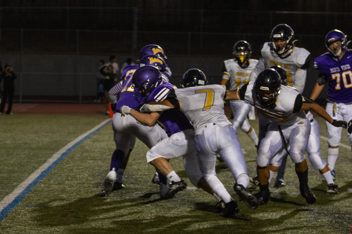 A Matador attempts to run past an opponent as he gets tackled.