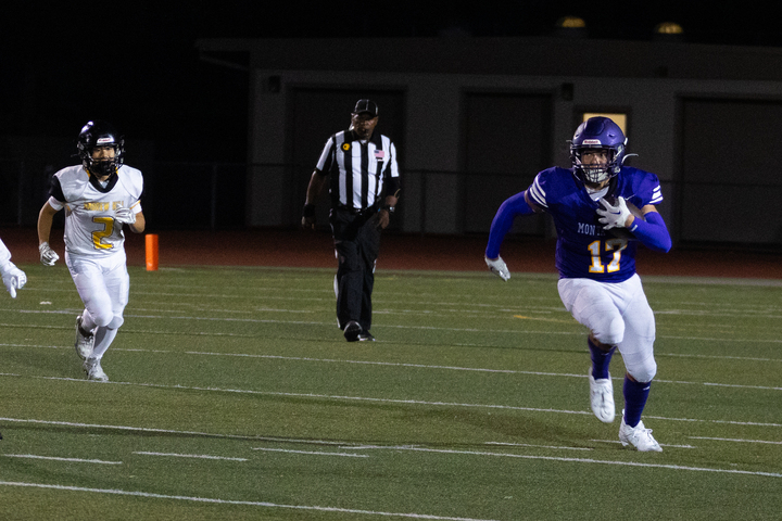 Junior and quarterback Graham Ischo runs down the field with the ball.