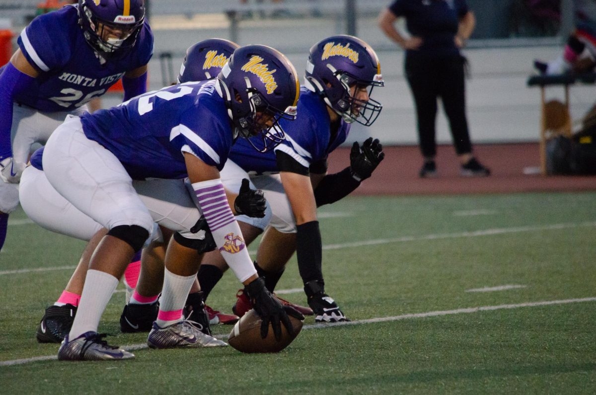 Junior Krish Kotecha readies himself to hike the ball and start the game.