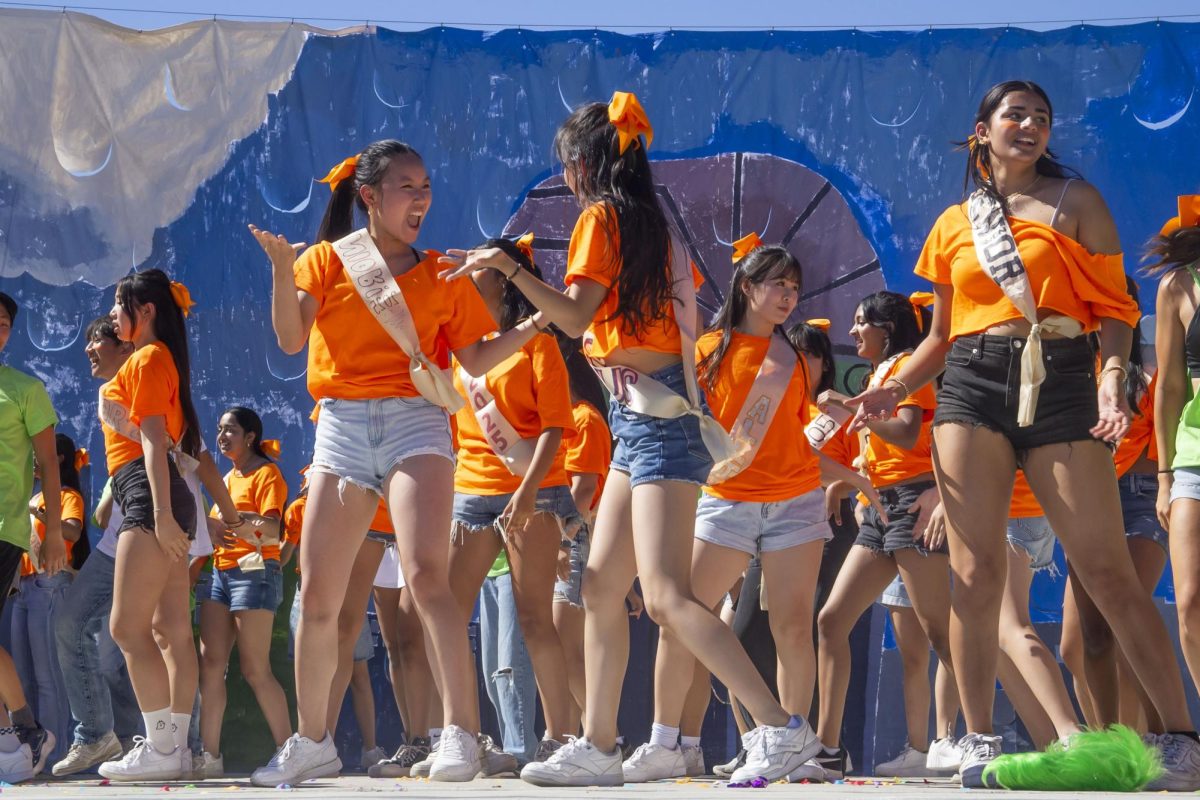 Seniors Alyssa Yang and Lotus Wu smile at each other in the co-ed dance.