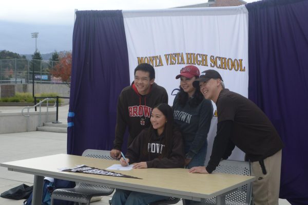 Senior Clara Fan poses with her family during her signing