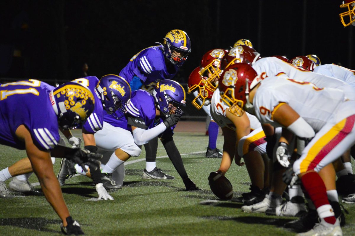 CHS center hikes the ball from the line of scrimmage to begin the play in the 2023-2024 Helmet Game.