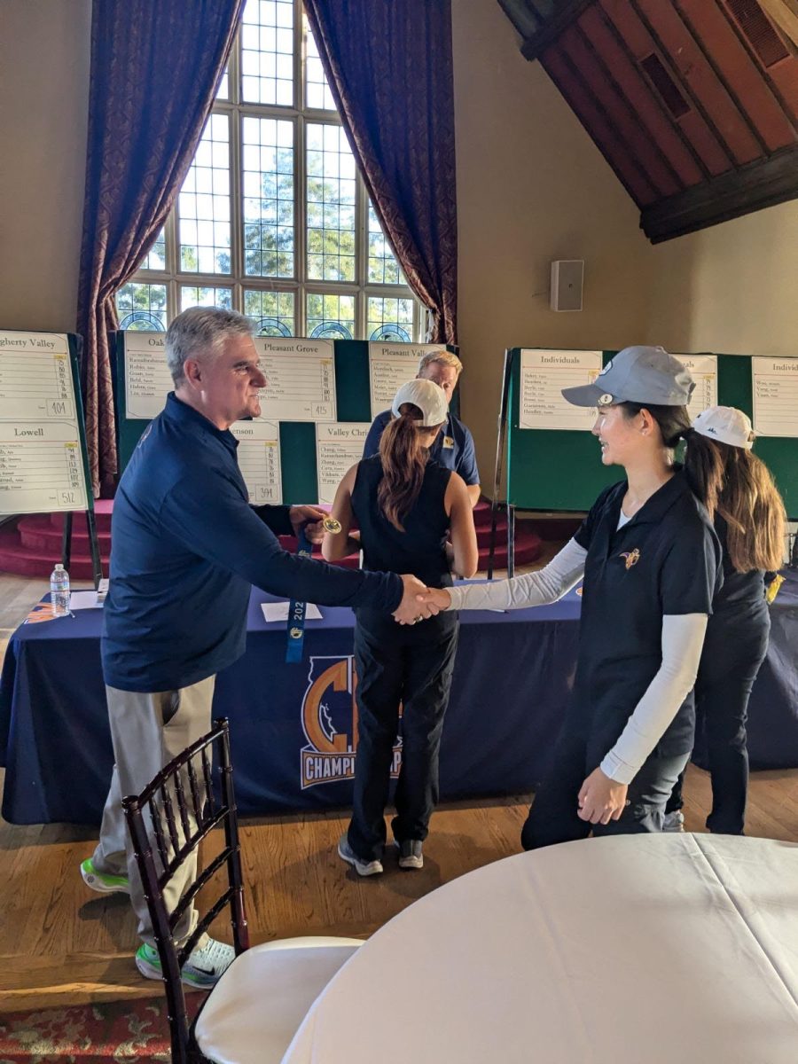 Freshman Michelle Wang shakes hands with a CIF commissioner after individually qualifying for CIF State Championships. Photo by Kenneth Gan | Used with permission
