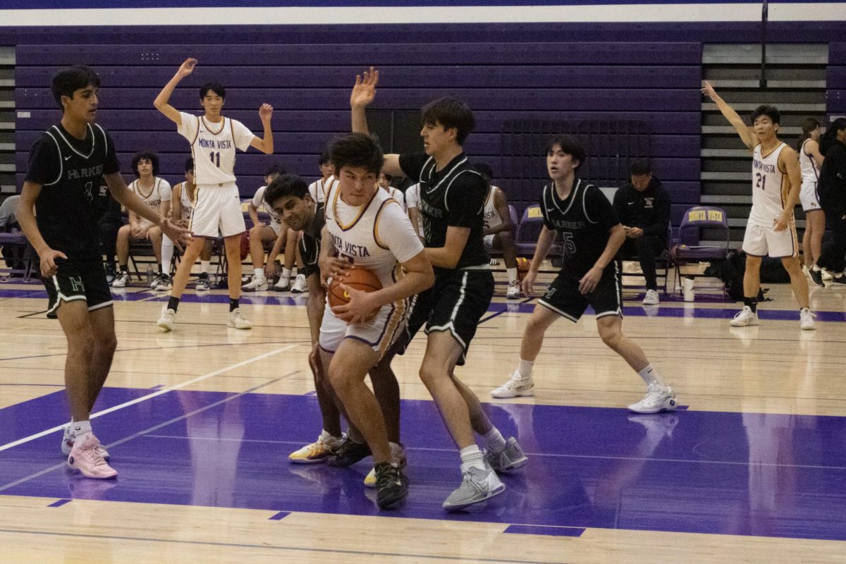 Junior and power forward Sean Foo holds the ball close to prevent a Harker player from stealing the ball.