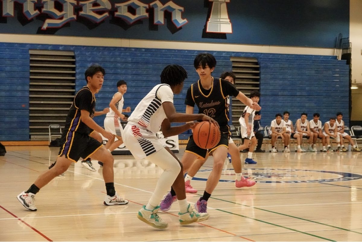 Junior Kendrick Wong attempts to intercept the ball as the opponent brings it down the court. 