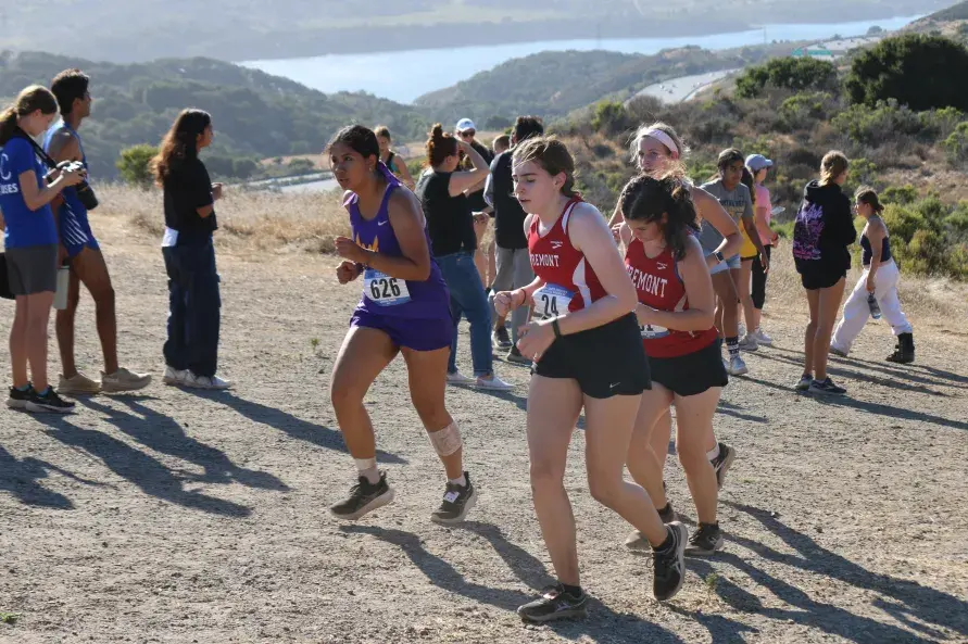 Senior Juliana Bañes (in purple) runs up a hill. Photo courtesy of Ryan Liu | Used with permission