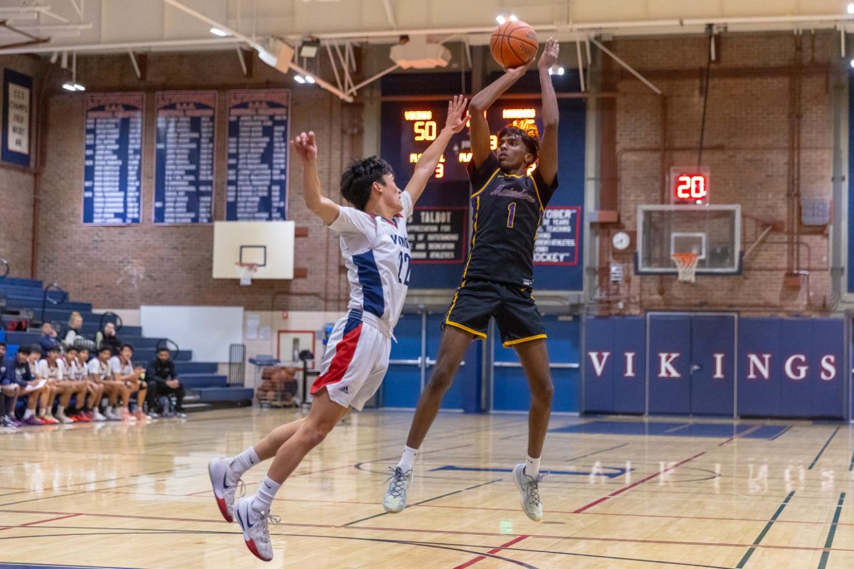 Senior and captain Ninad Suresh shoots a mid-range fadeaway jump shot over his defender to bring the score to 47-50. Photo | Katrina Lin
