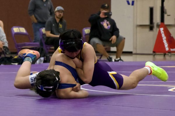 Sophomore John Chang tackles a MHS wrestler in the third round of the first tri-dual meet of the team’s season. 