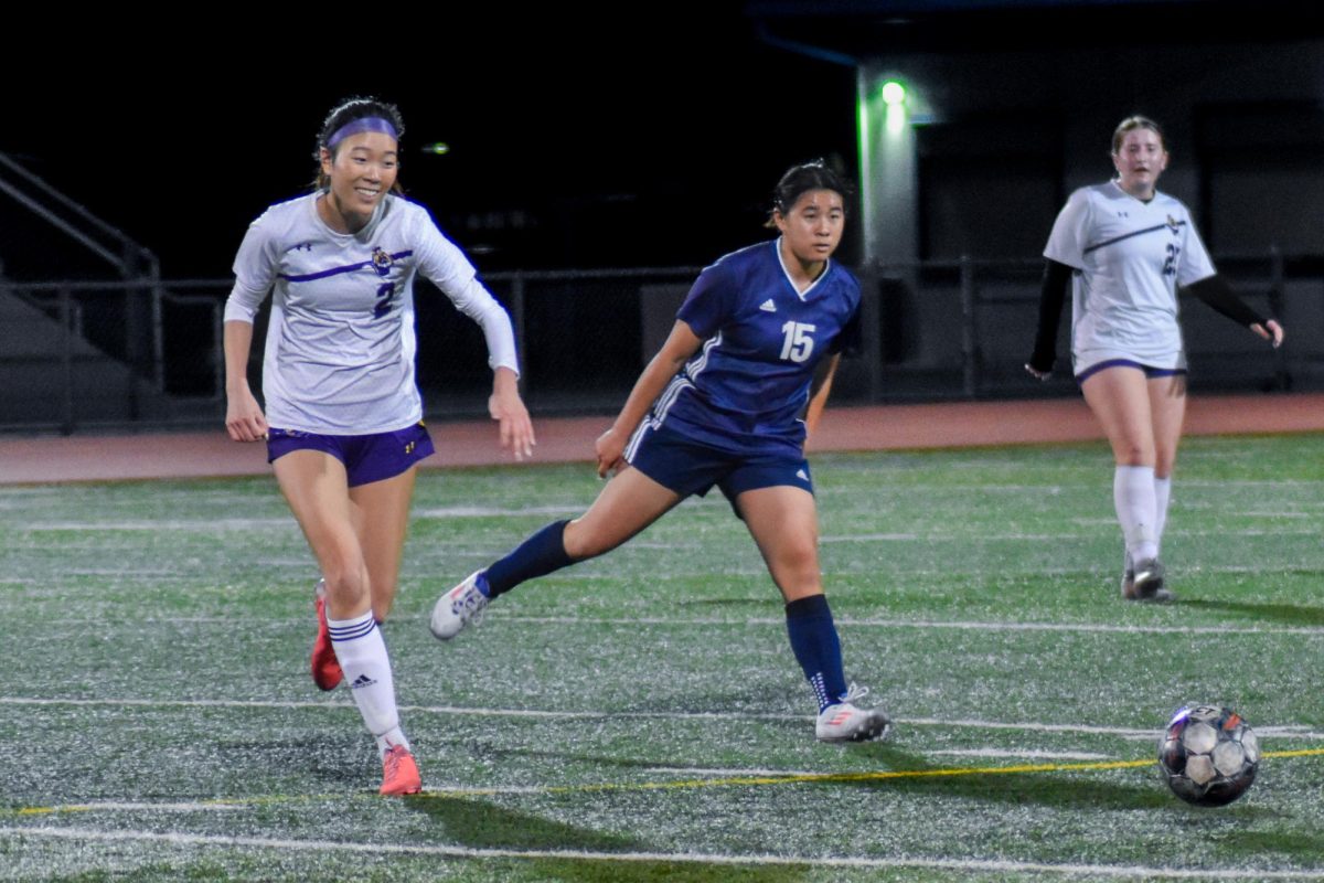 Senior Dylan Hwang fights against a Lynbrook player over possession of the ball.