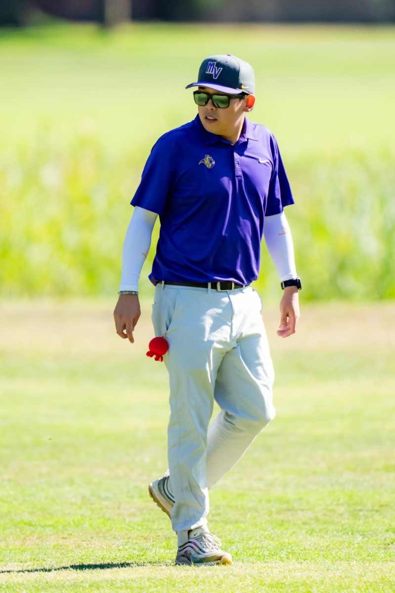 Coach Gan surveys the field as team plays