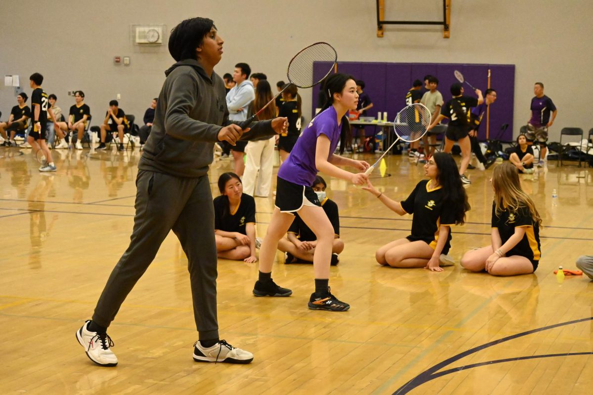 Junior Pranav Balasubramanian plays alongside junior Ning He during their mixed doubles game.