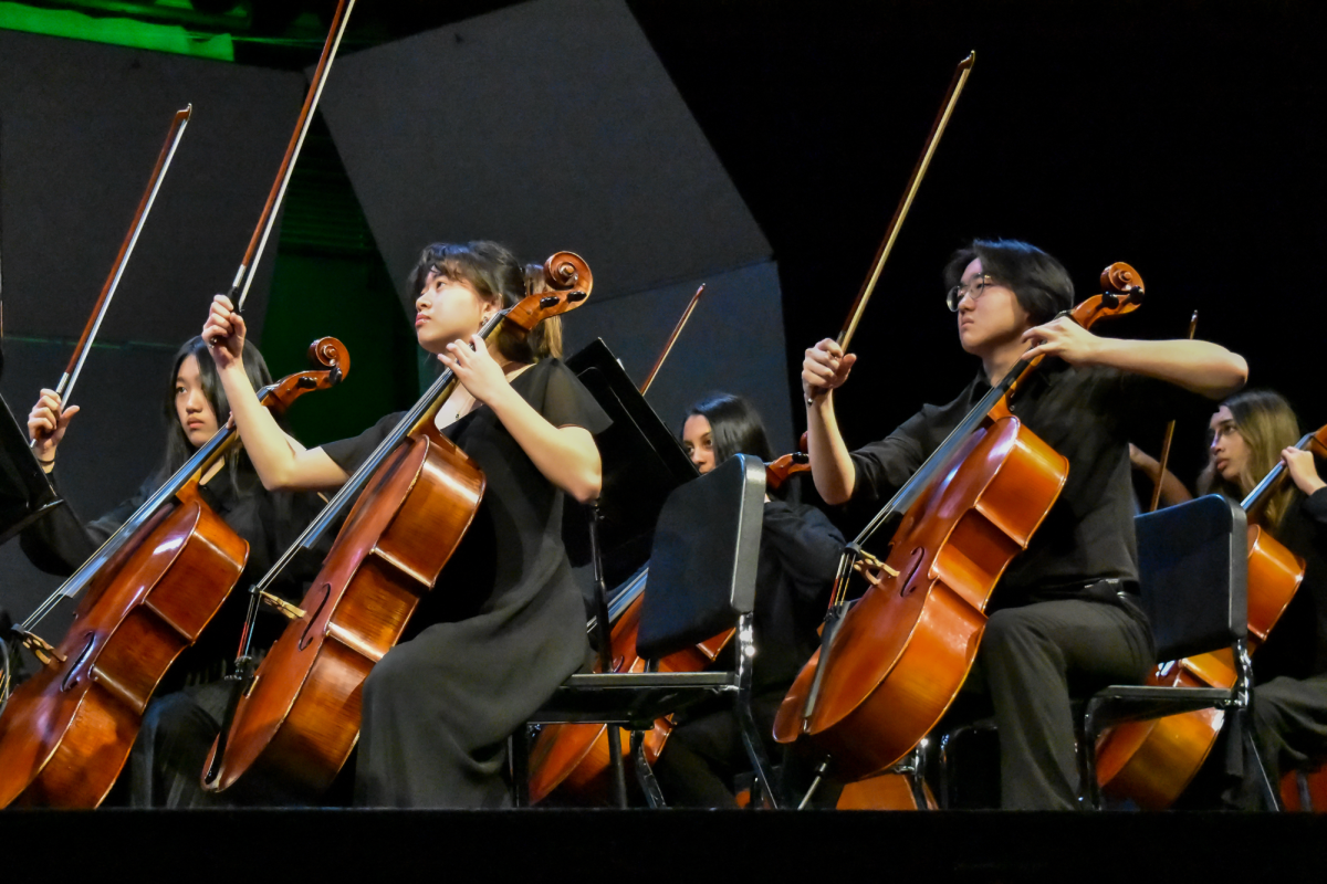 Junior cellist Elspeth Luu and senior cellist Robin Yoon hold their bows up, signifying the end of a piece. Photo | Angela Poon