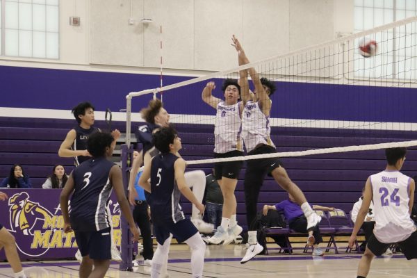 Middle blocker Pratham Kannan and opposite hitter Charlie Jiang attempt to block LHS’ spike. 