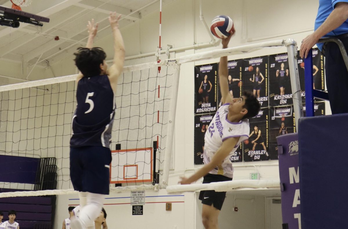 Senior and outside hitter Praneel Shah attempts to spike the ball over the net. 