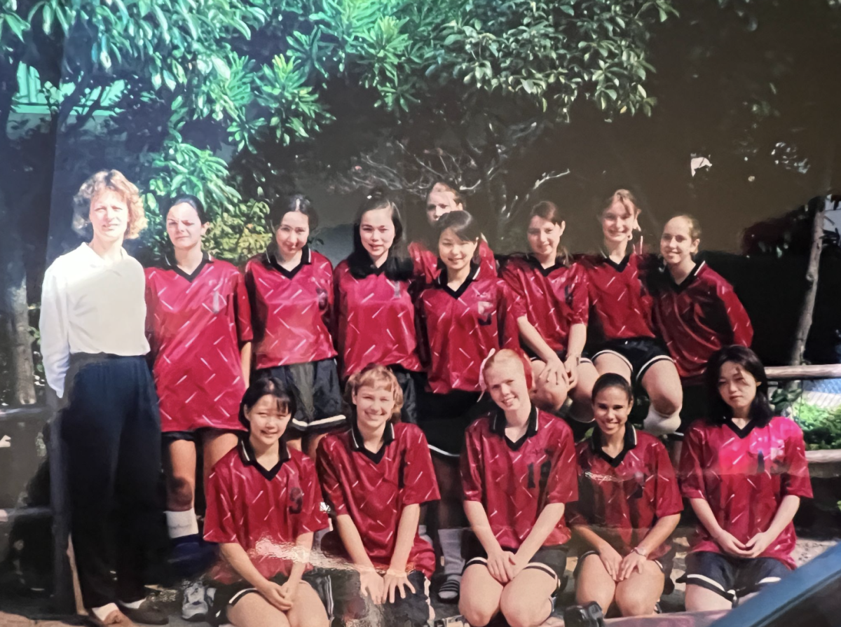 Journalism teacher Julia Satterthwaite (top right) poses with her high school volleyball team at Canadian Academy. Photo courtesy of Julia Satterthwaite | Used with permission
