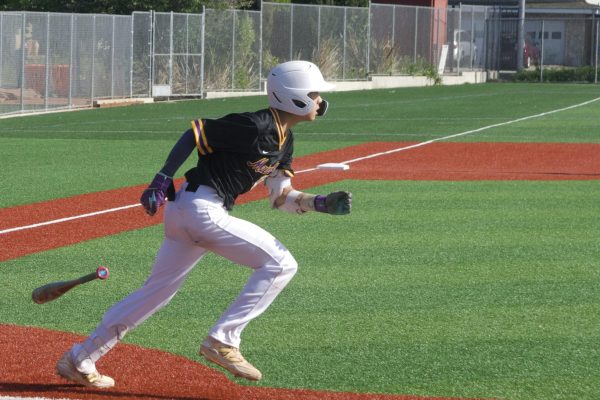 Junior and hitter Timothy Yin drops his bat and hastily runs towards first base.  Photo | Raj Thapliyal