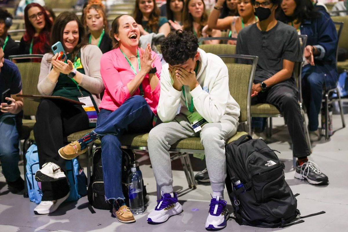 Former El Estoque Editor-in-Chief Alan Tai sits in shock alongside journalism adviser Julia Satterthwaite after winning National Journalist of the Year for 2025. Photo | Chris Waugaman