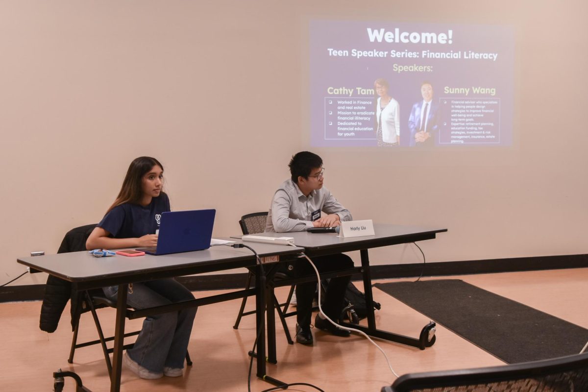 Two financial experts presented about the principles of personal finance to a room of students