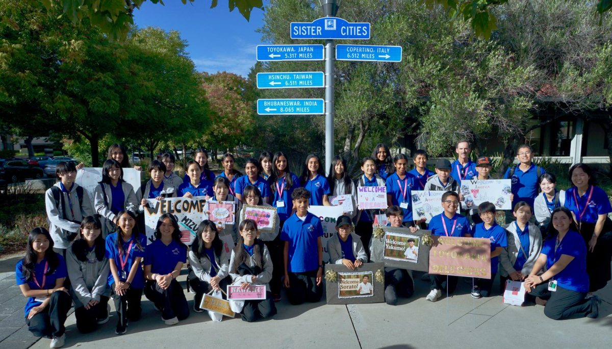 The Cupertino and Toyokawa delegations pose together in front of the Sister Cities sign in Cupertino, Calif.. Photo courtesy of Beth Wichmann | Used with permission