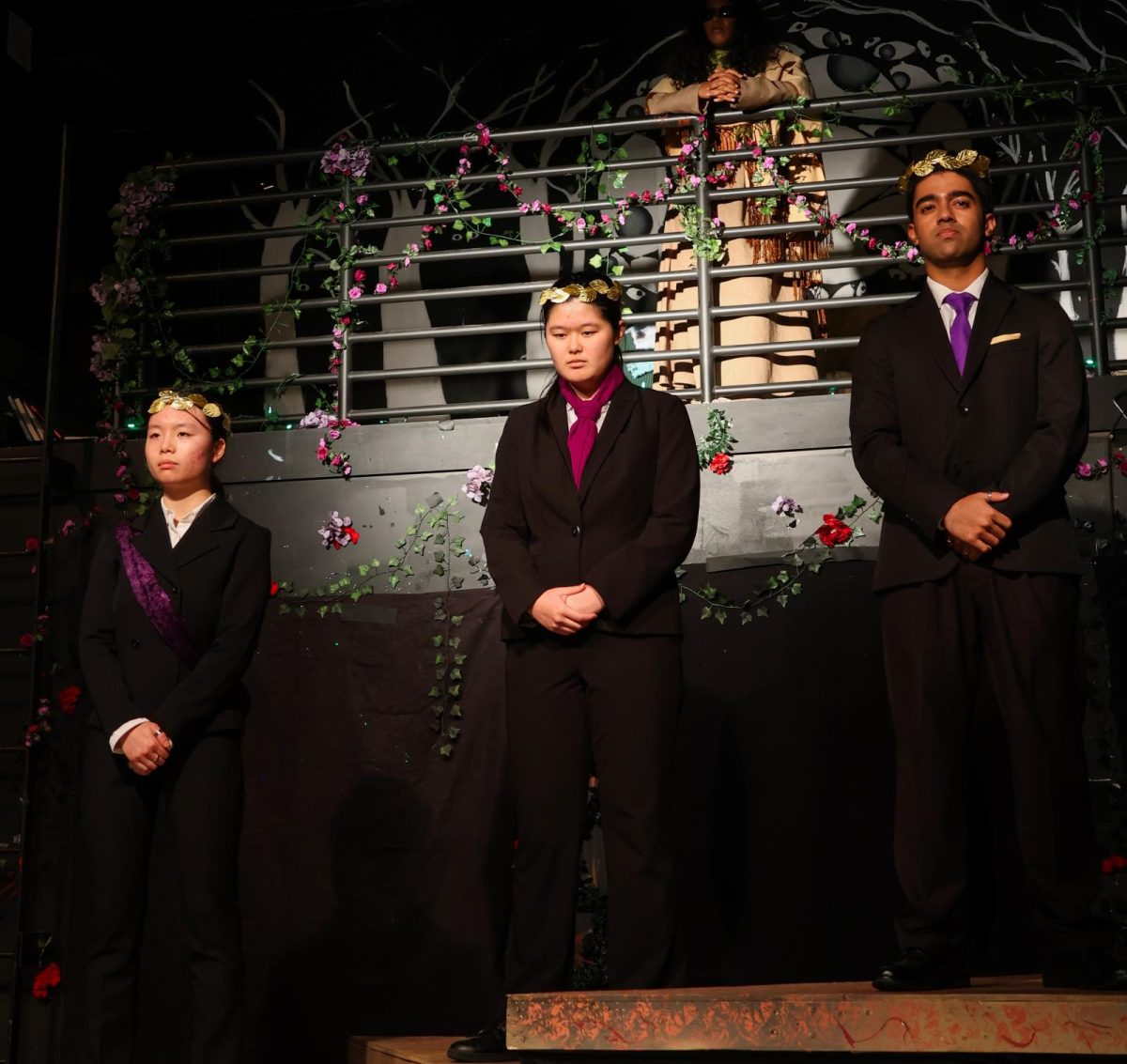 Senior Shrinjoy Chaudhuri, senior Lea Chuang and junior Elizabeth Yang stand on raised platforms as three incarnations of King Creon, delivering a speech about the future of the kingdom, Thebes, under the new regime. Photo | Benjamin Zhang