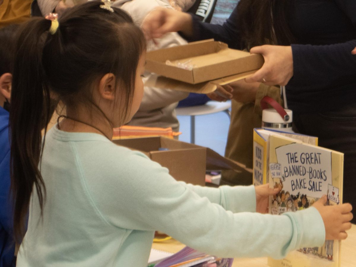 The nonprofit organization organized a table at the Cupertino Library putting together stationery supplies for distribution