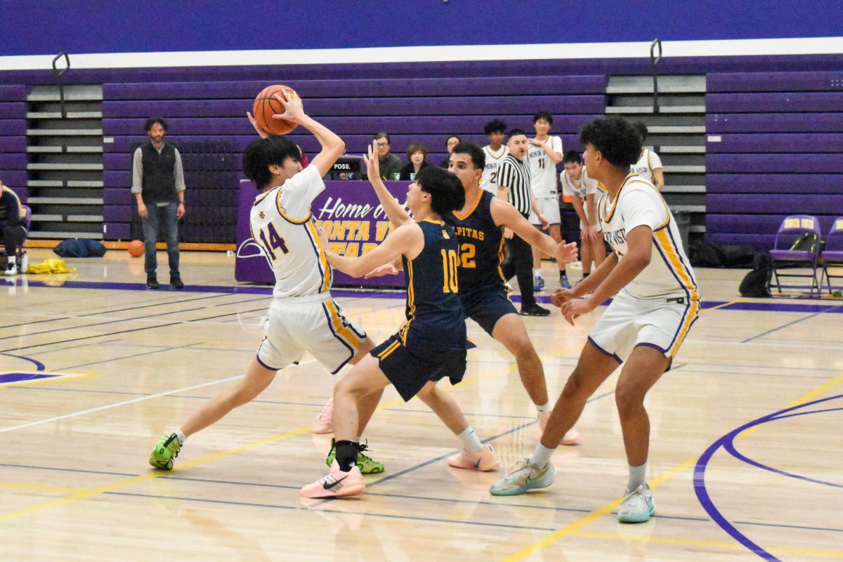 Junior and shooting guard Matthew Chan attempts to pass the ball over MHS' two defenders. Photo | Leah Desai